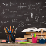 blackboard with science images with books and pencils in front