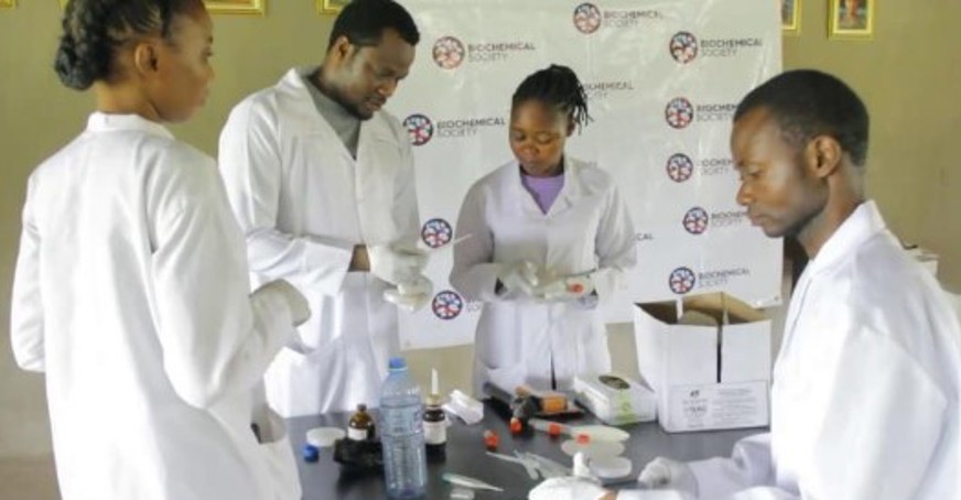 Group of students preparing for experiment on oxygen release by microbes