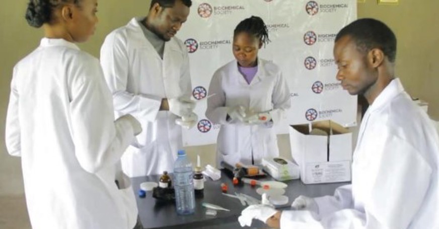 Group of students preparing for experiment on oxygen release by microbes