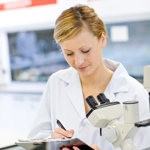 Scientist recording experiments in the lab.